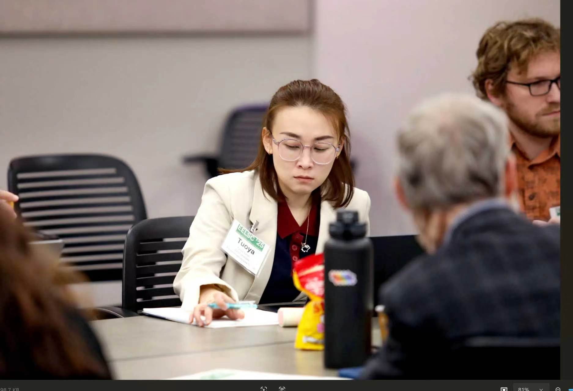 Participating in a conference discussion.